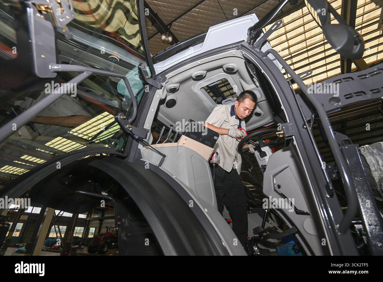 QINGZHOU, CHINA - SEPTEMBER 10, 2025 - A worker assembles a high ...