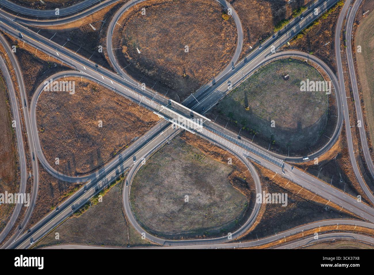 Aerial view of beautiful highway road junction in clover shape at summer day. Logistic concept Stock Photo