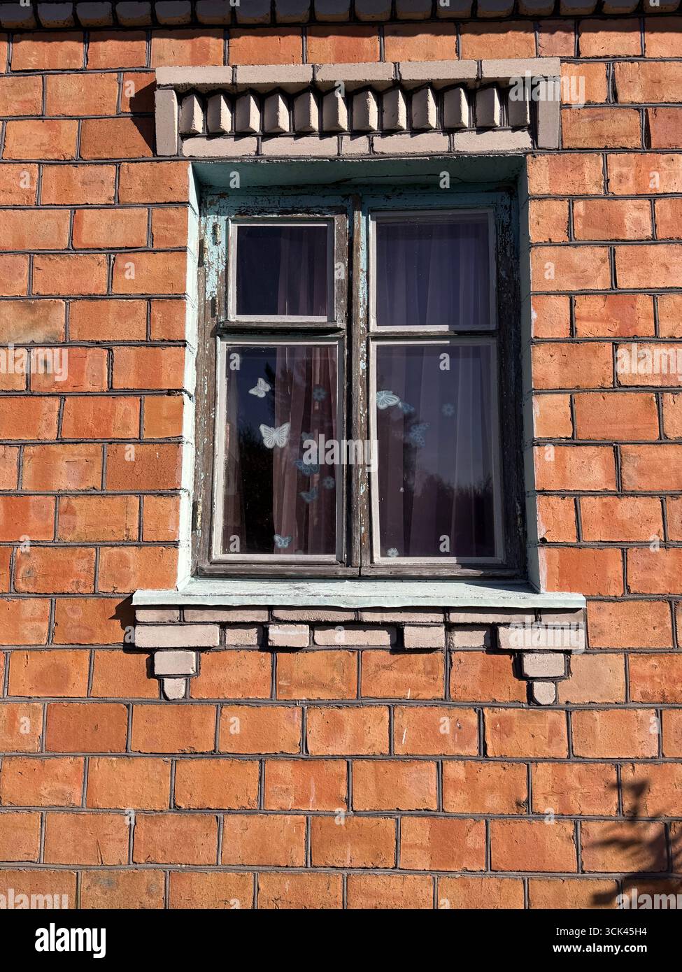 Window in a brick house. Dilapidated window frame. Stock Photo