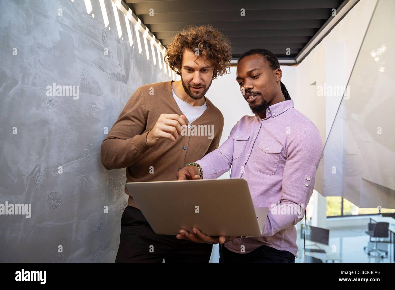 Mixed team of software engineers brainstorming ideas. Diverse app developers collaborating as group Stock Photo