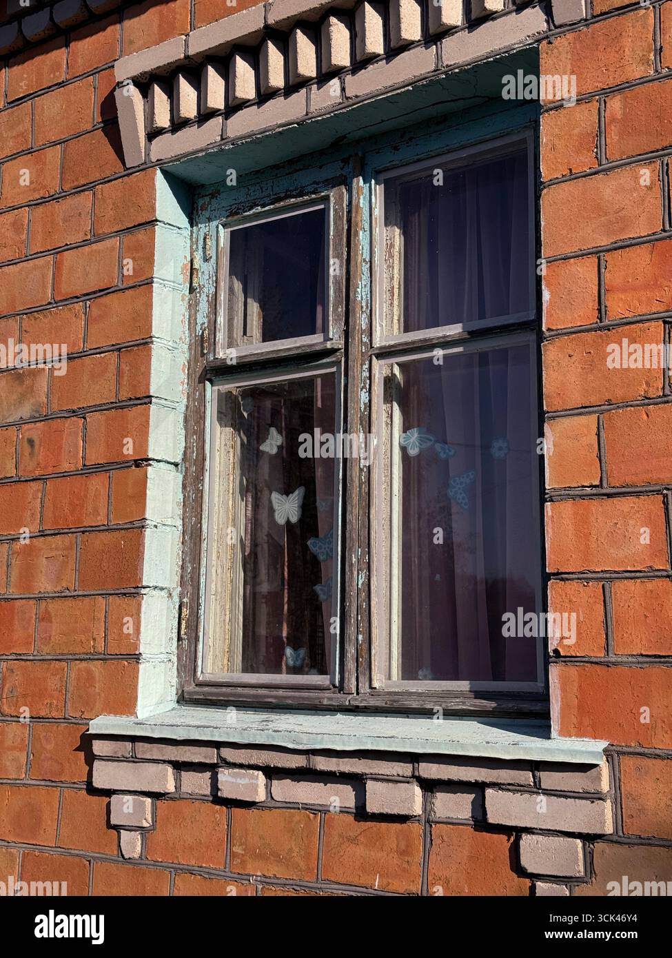 Window in a brick house. Dilapidated window frame. Stock Photo
