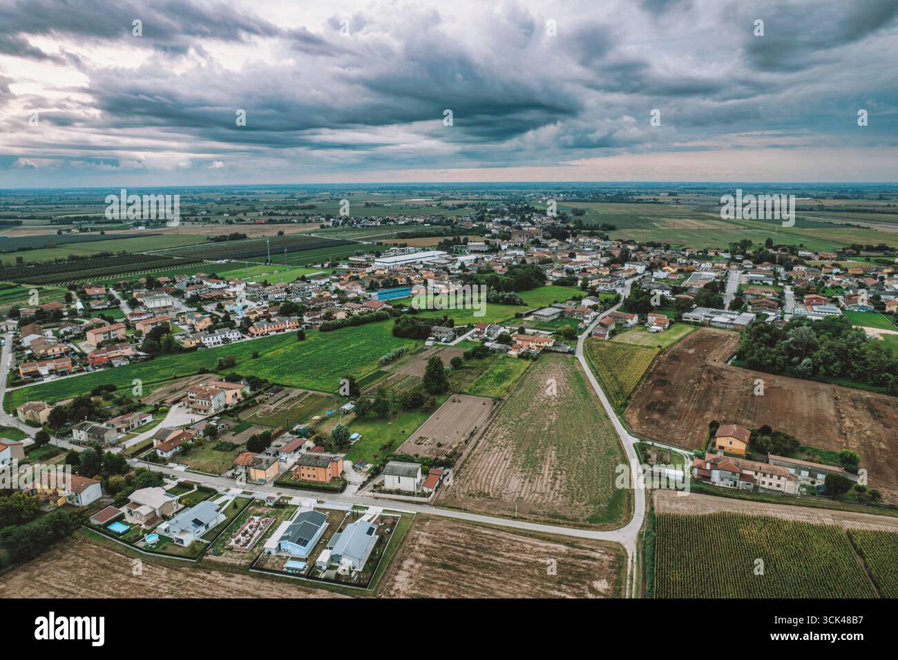 Aerial view of the po valley countryside in italy shows a small village ...