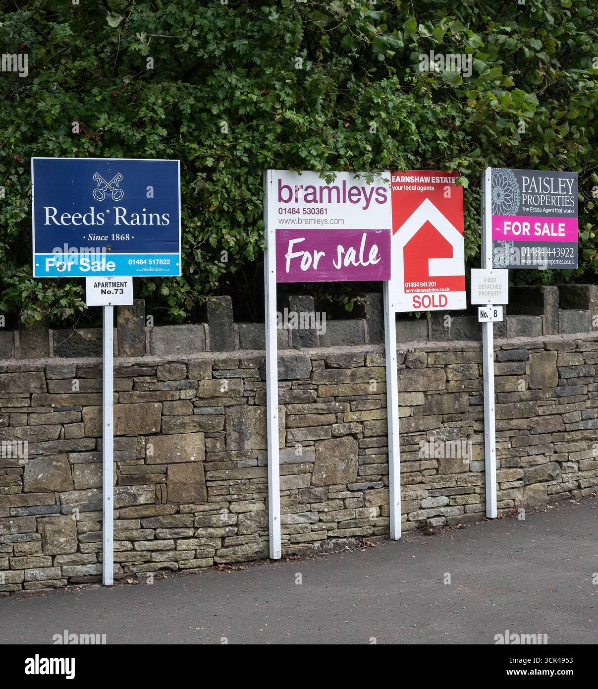 A series of Estate agents For Sale signs advertising house sales in the West Yorkshire area, U.K. Stock Photo