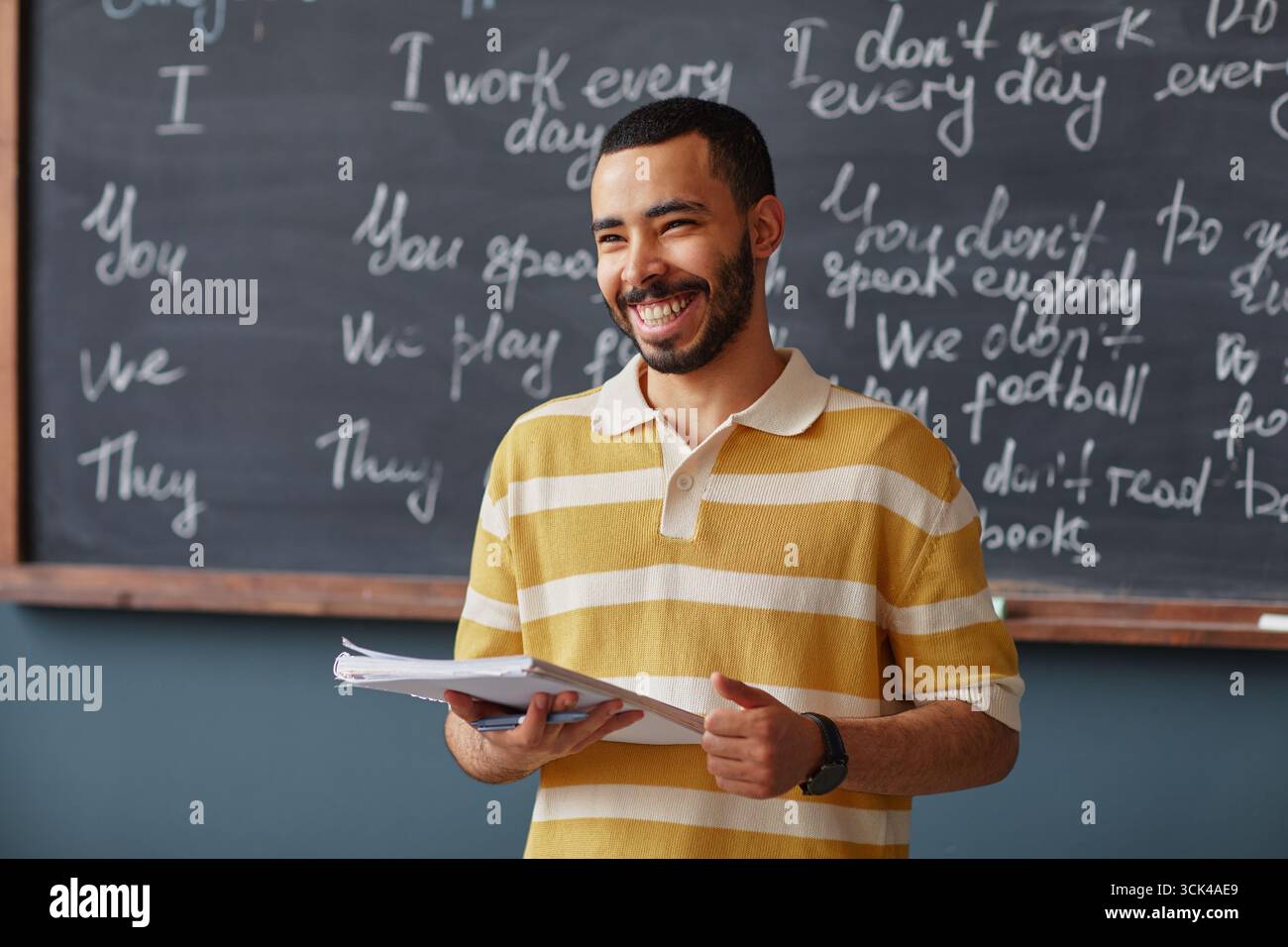 Adult Middle Eastern Man Smiling While Teaching Language Lesson Stock Photo
