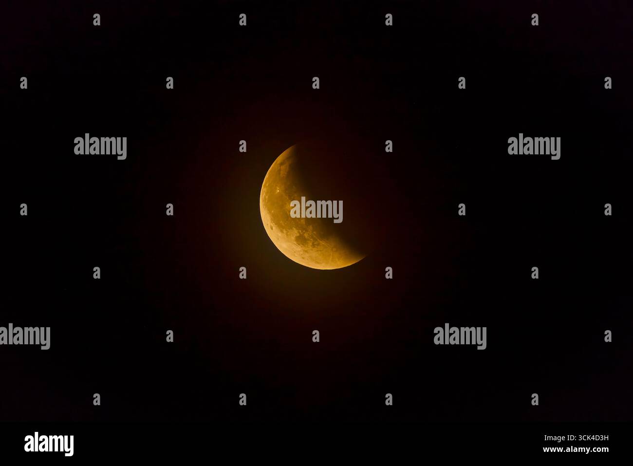 red full moon during the eclipse seen at half-coverage Stock Photo