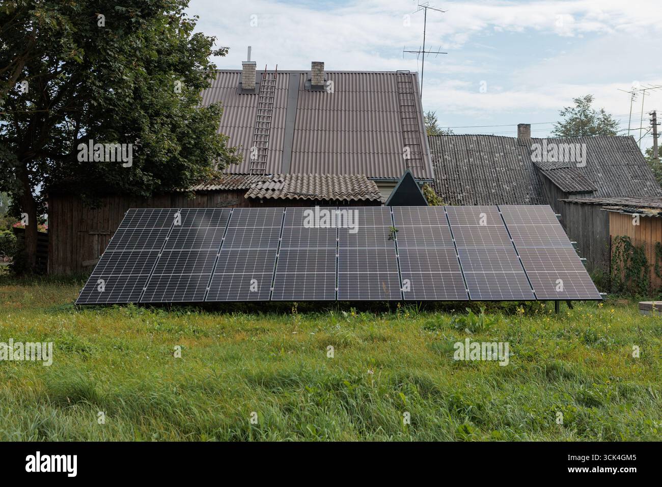 Solar panels installed in front of old rural house Stock Photo