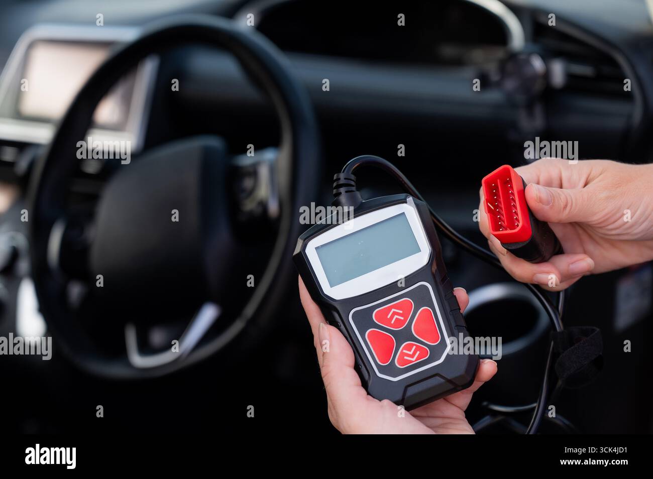 Woman using OBD2 diagnostic scanner.  Stock Photo