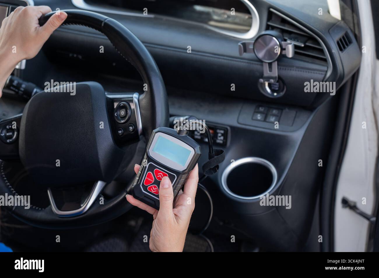 Woman using OBD2 diagnostic scanner.  Stock Photo