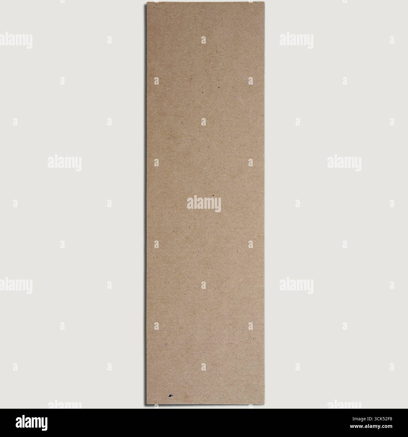 A plain rectangular piece of cardboard, likely for crafting or packaging purposes. Stock Photo