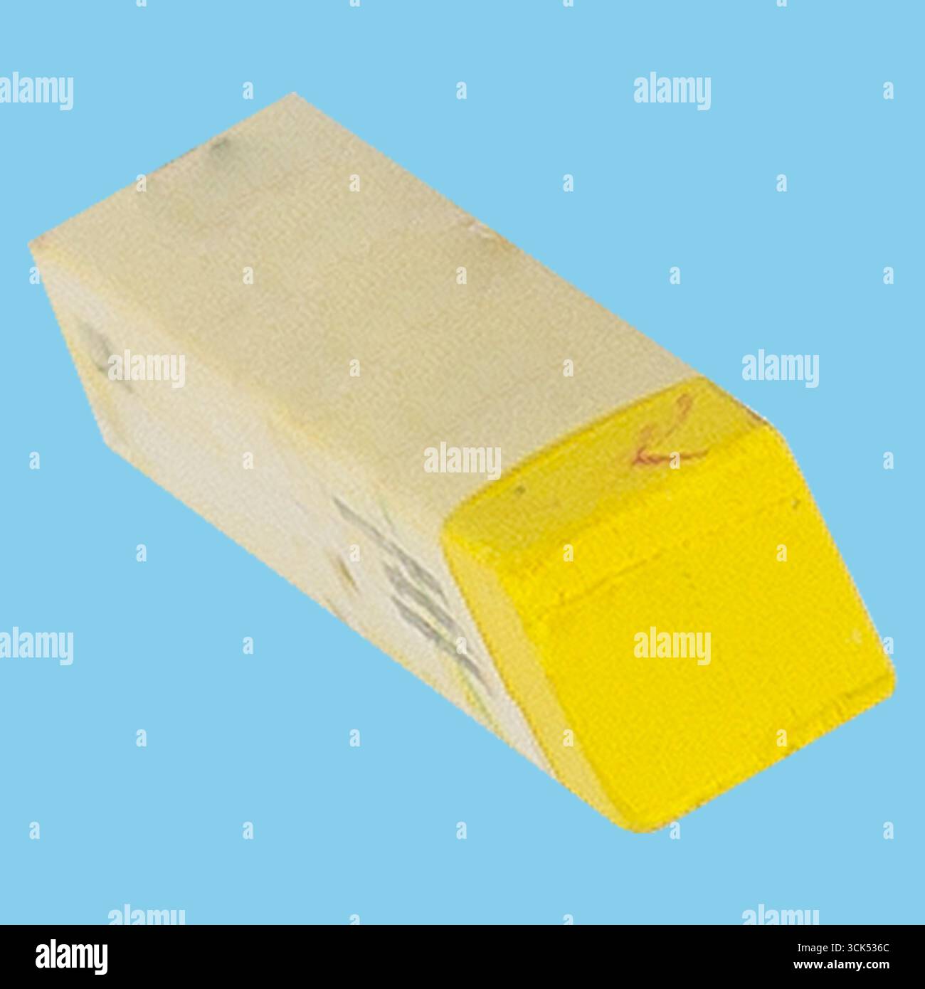 A yellow eraser with a rectangular shape, commonly used for correcting pencil marks on paper. Stock Photo
