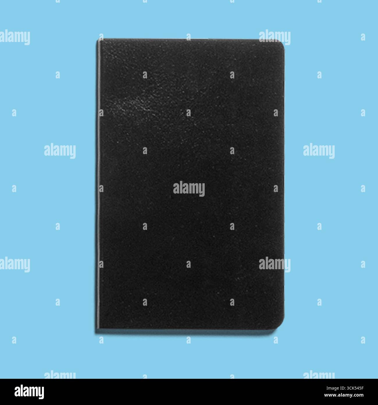 A plain black notebook, ideal for writing notes, sketches, or journaling. Stock Photo
