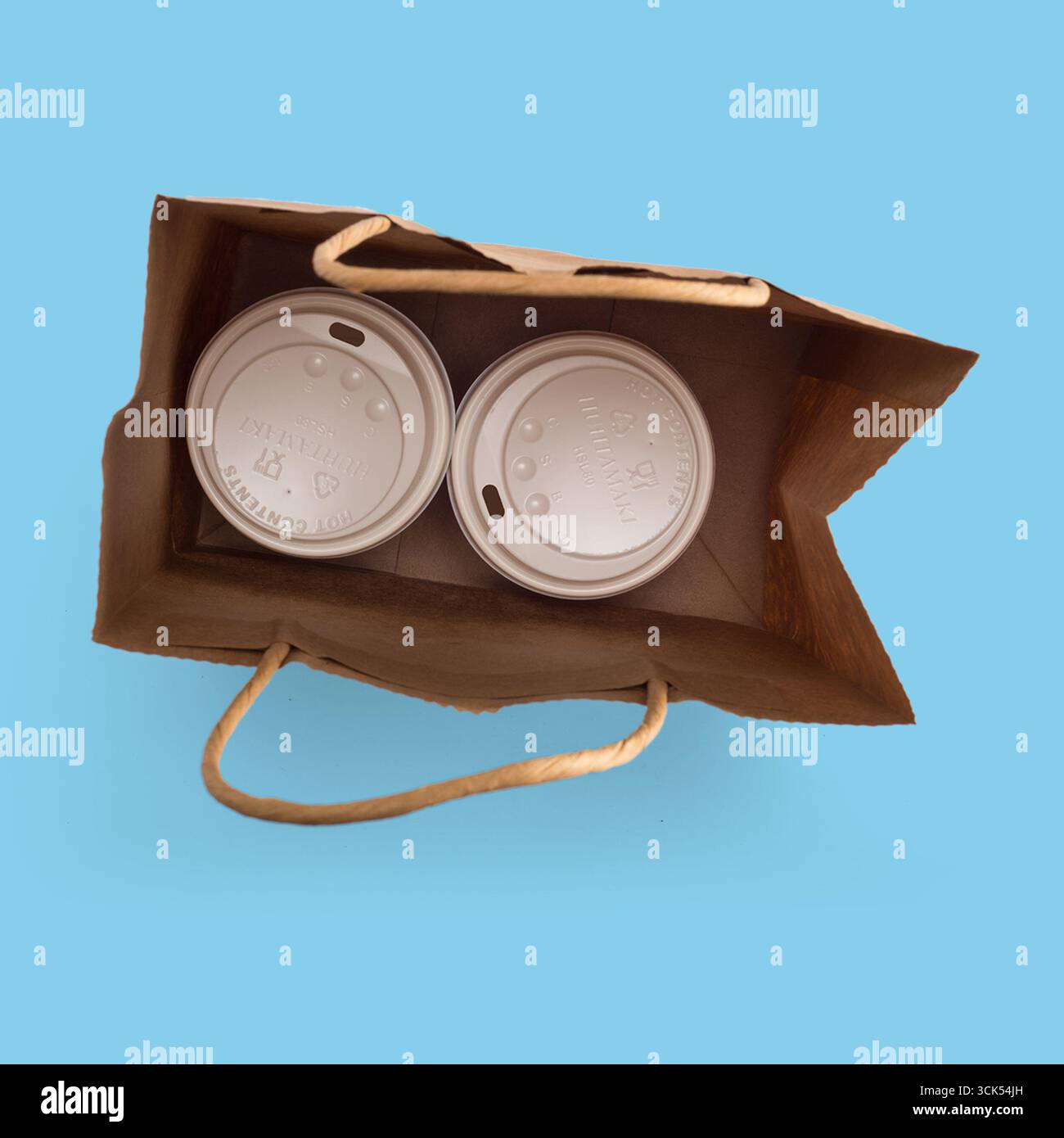 Two beverage cups inside a paper bag, ready for takeout. Stock Photo