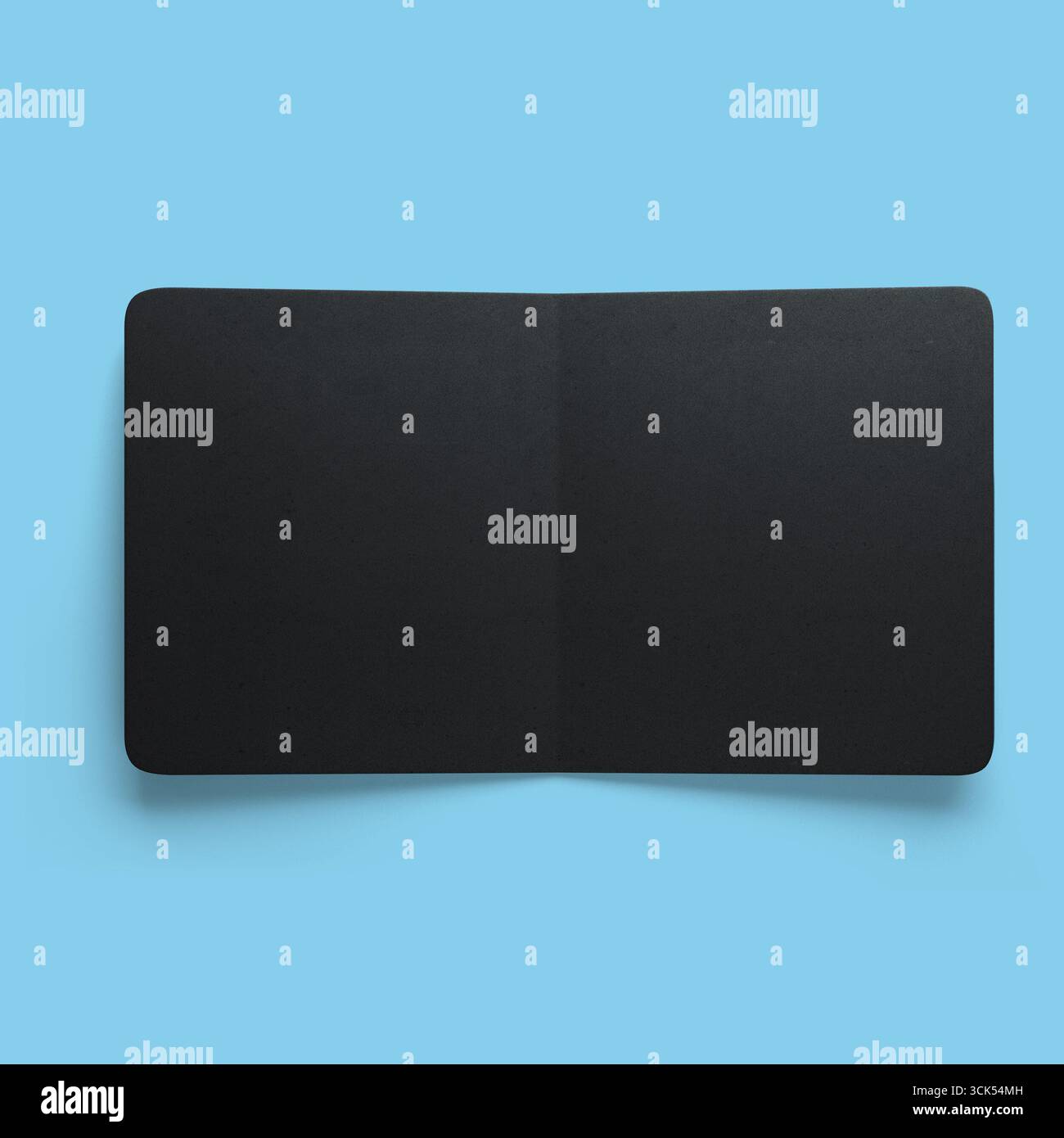 A sleek, minimalist black rectangular object, possibly a notebook or a tablet cover, emphasizing simplicity and elegance. Stock Photo