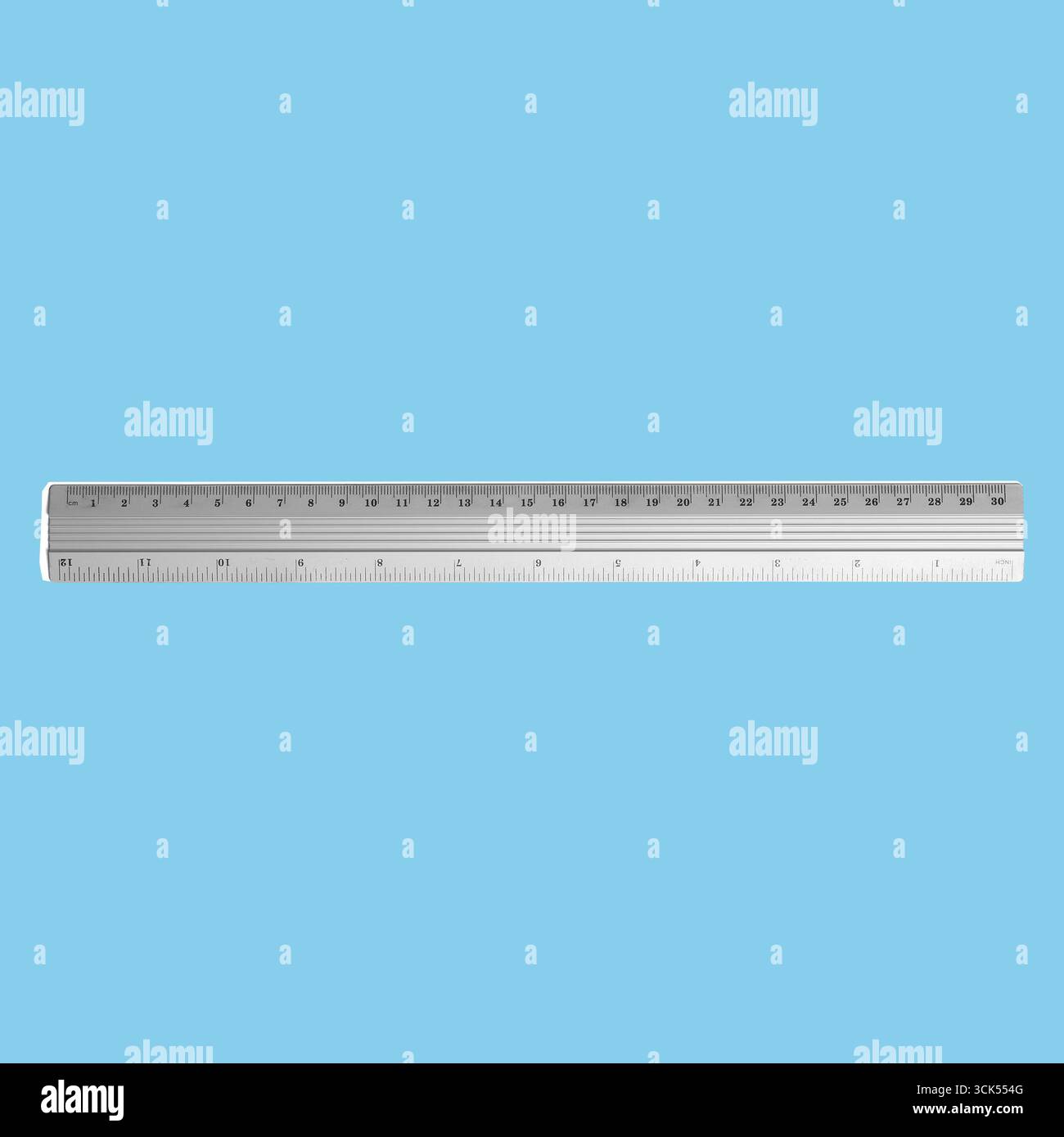 Silver Scale Ruler A silver ruler used for measuring and drawing straight lines, featuring ...