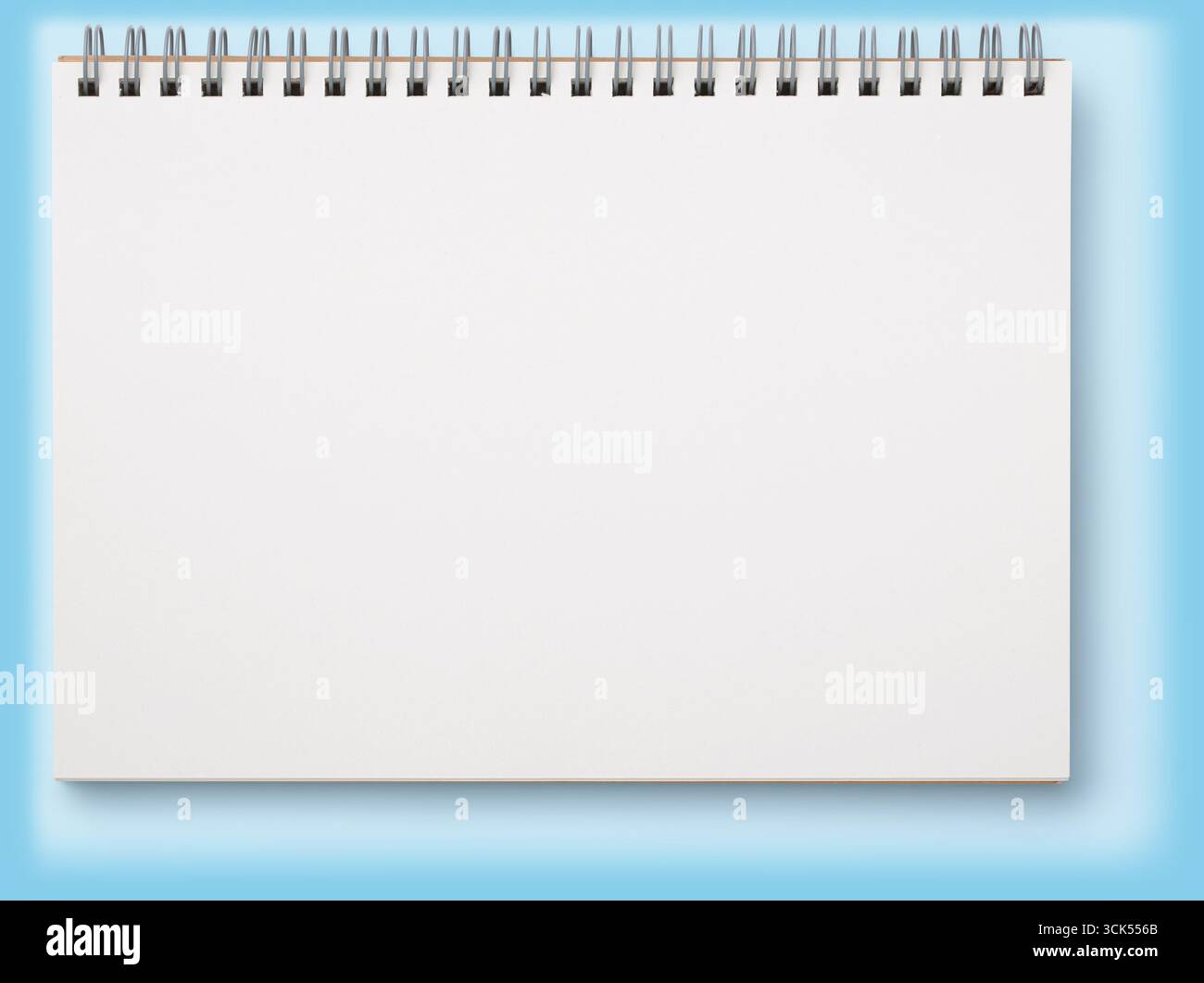 A blank spiral notebook ready for notes or sketches. Stock Photo