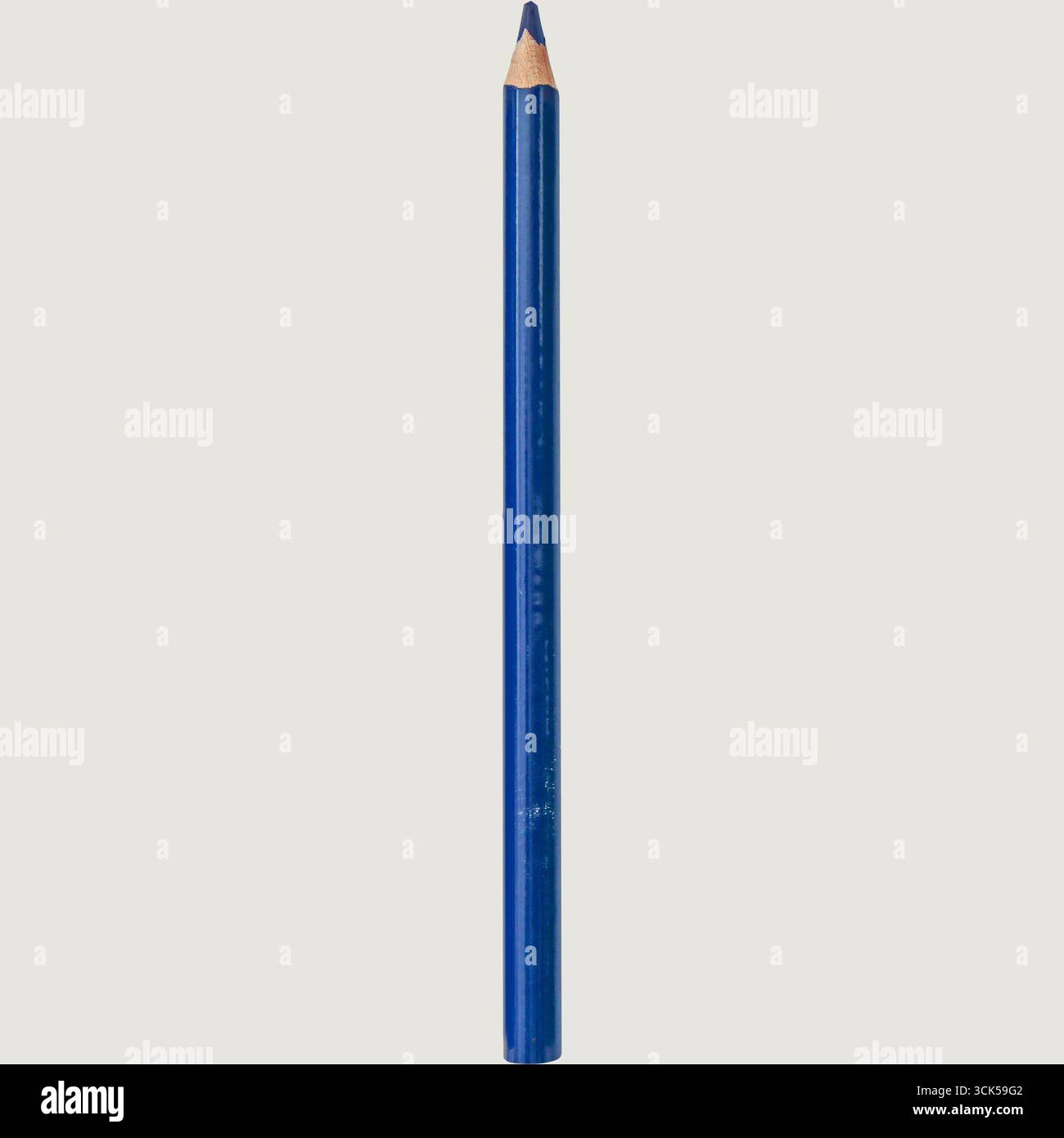 A blue colored pencil with a sharpened tip, used for drawing and coloring. Stock Photo