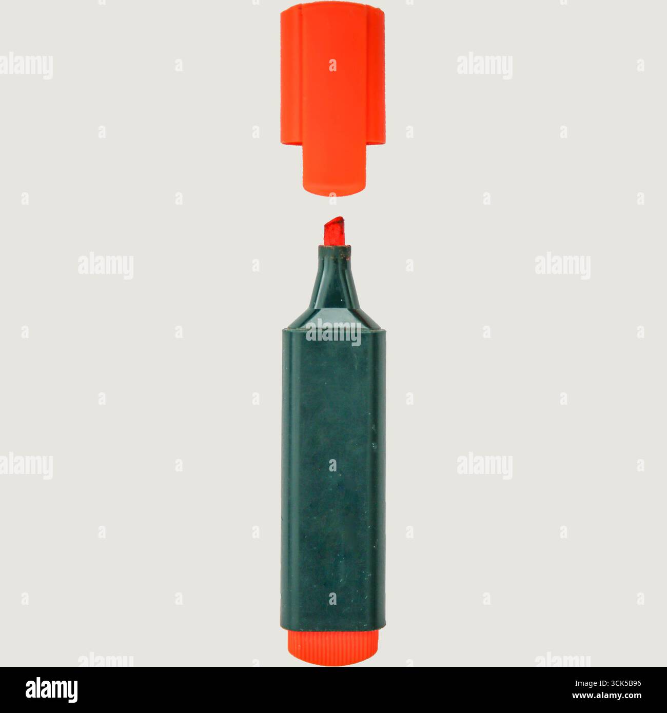 A red highlighter marker with its cap removed, showcasing its chiseled tip for highlighting text. Stock Photo