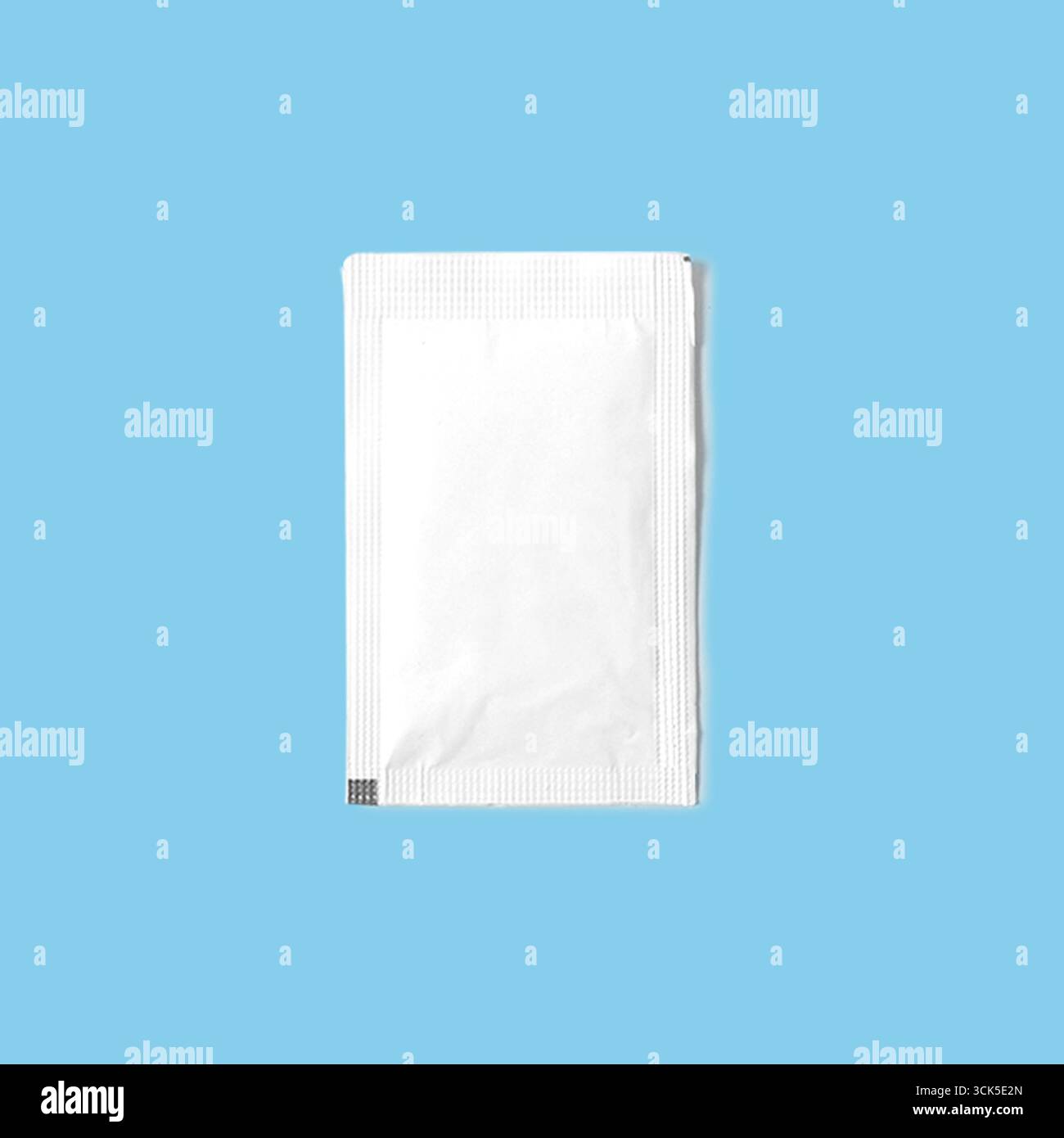 A plain white packet, likely containing a single-use product or sample. Stock Photo