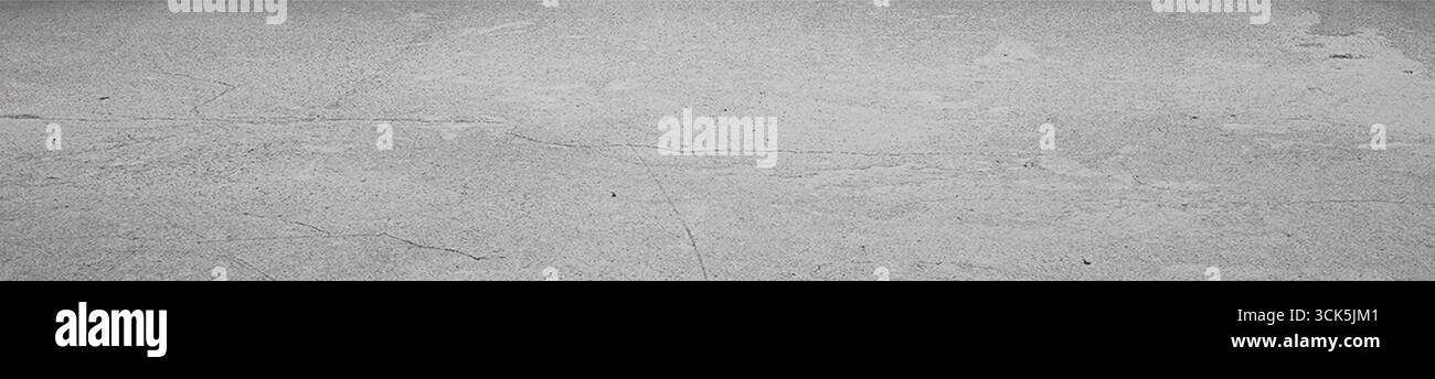 A textured gray surface with subtle patterns, possibly concrete or stone, suitable for backgrounds or design purposes. Stock Photo