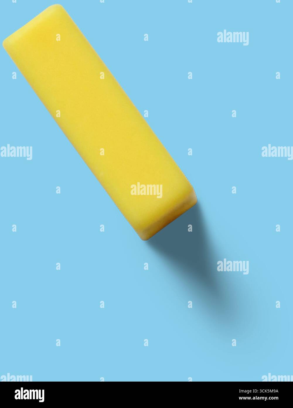 This image shows a yellow rectangular eraser, commonly used for correcting pencil marks on paper. Stock Photo