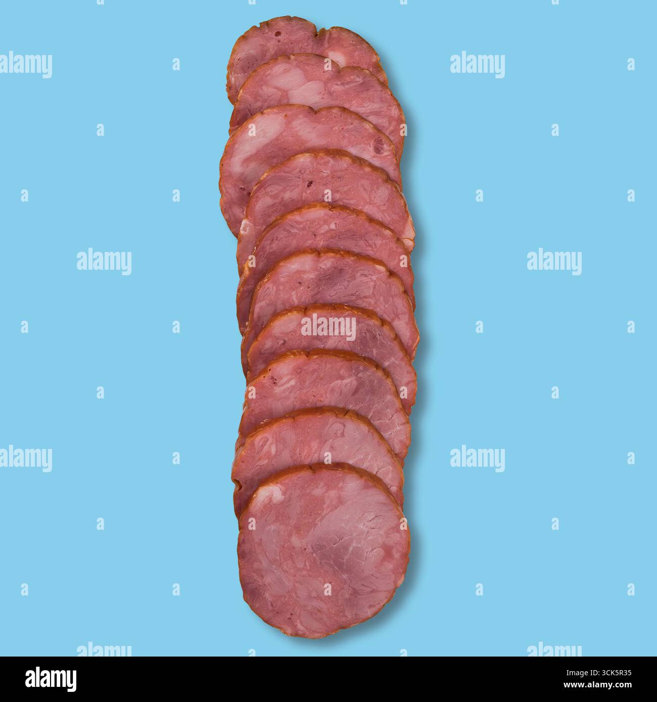 A stack of thinly sliced deli meat arranged neatly. Stock Photo