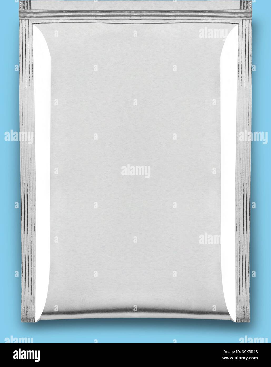 A plain silver foil packet, often used for packaging food or other products. Stock Photo