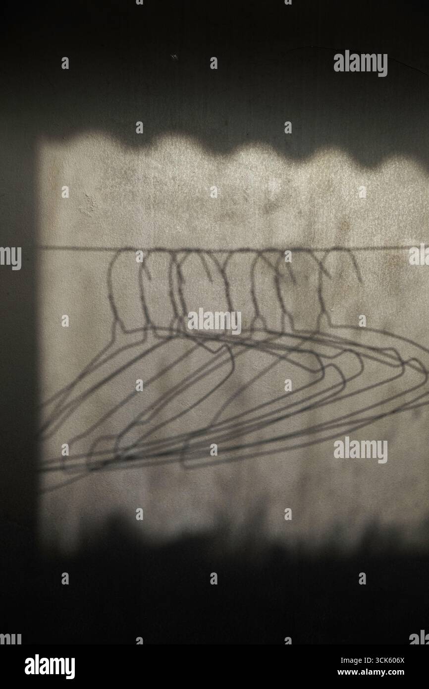 Shadow of hanger exposed to sunlight Stock Photo - Alamy