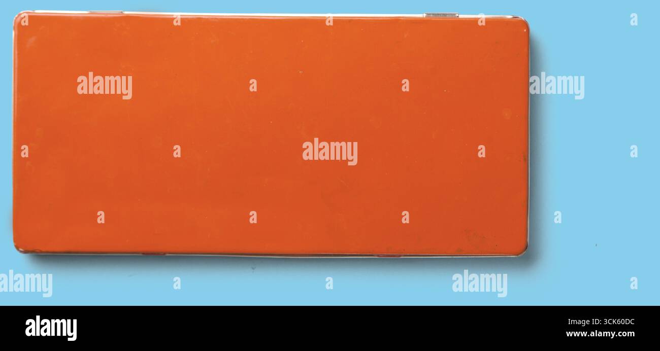 A simple orange rectangular object, possibly a container or box, with a smooth surface and no visible markings. Stock Photo