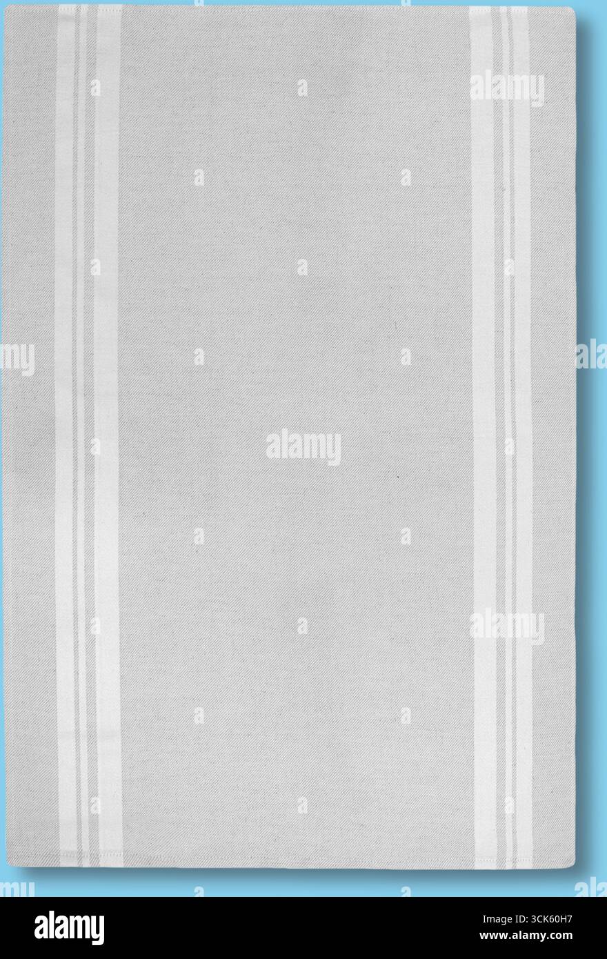 A plain, textured surface with two vertical stripes, possibly a tablecloth or fabric. Stock Photo