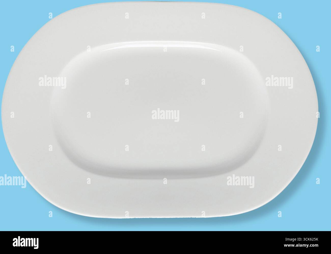 A simple white oval platter, designed for serving food elegantly. Stock Photo