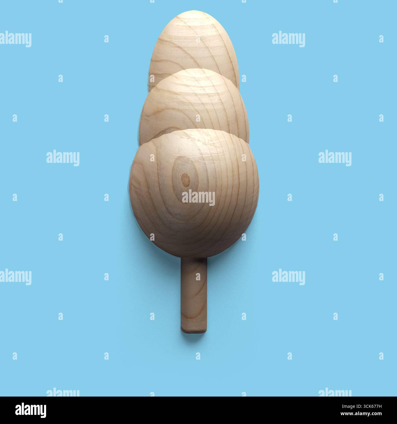 A wooden object resembling three stacked ovals on a stick, likely a decorative item or a toy. Stock Photo