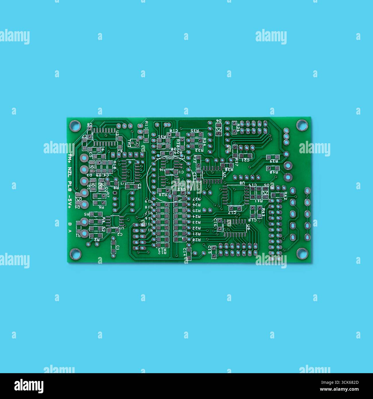 A printed circuit board (PCB) showcasing intricate electronic pathways and components for circuit assembly and functionality. Stock Photo