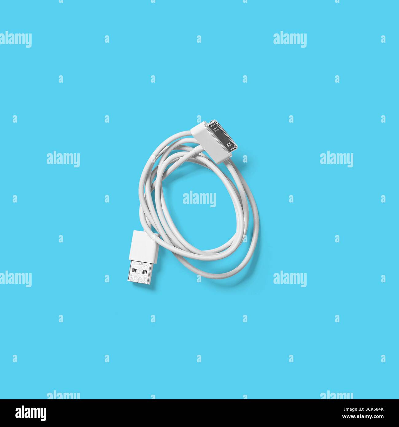 A white USB cable with connectors on both ends, used for data transfer and charging devices. Stock Photo