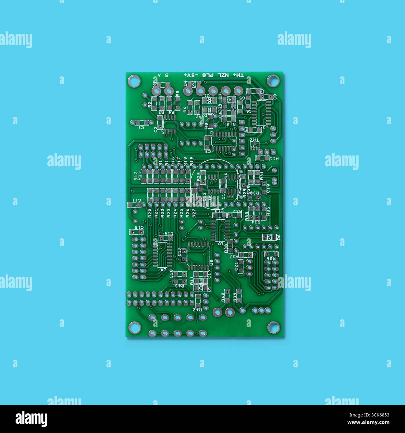 A printed circuit board (PCB) featuring various electronic components and connections for circuit design and functionality. Stock Photo