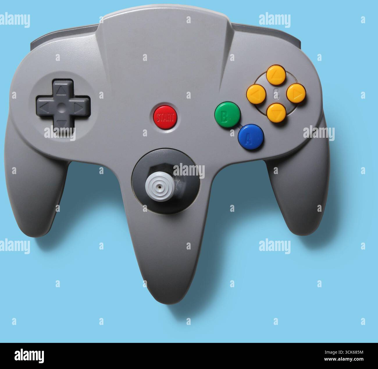 A classic video game controller with buttons and a joystick for gaming. Stock Photo