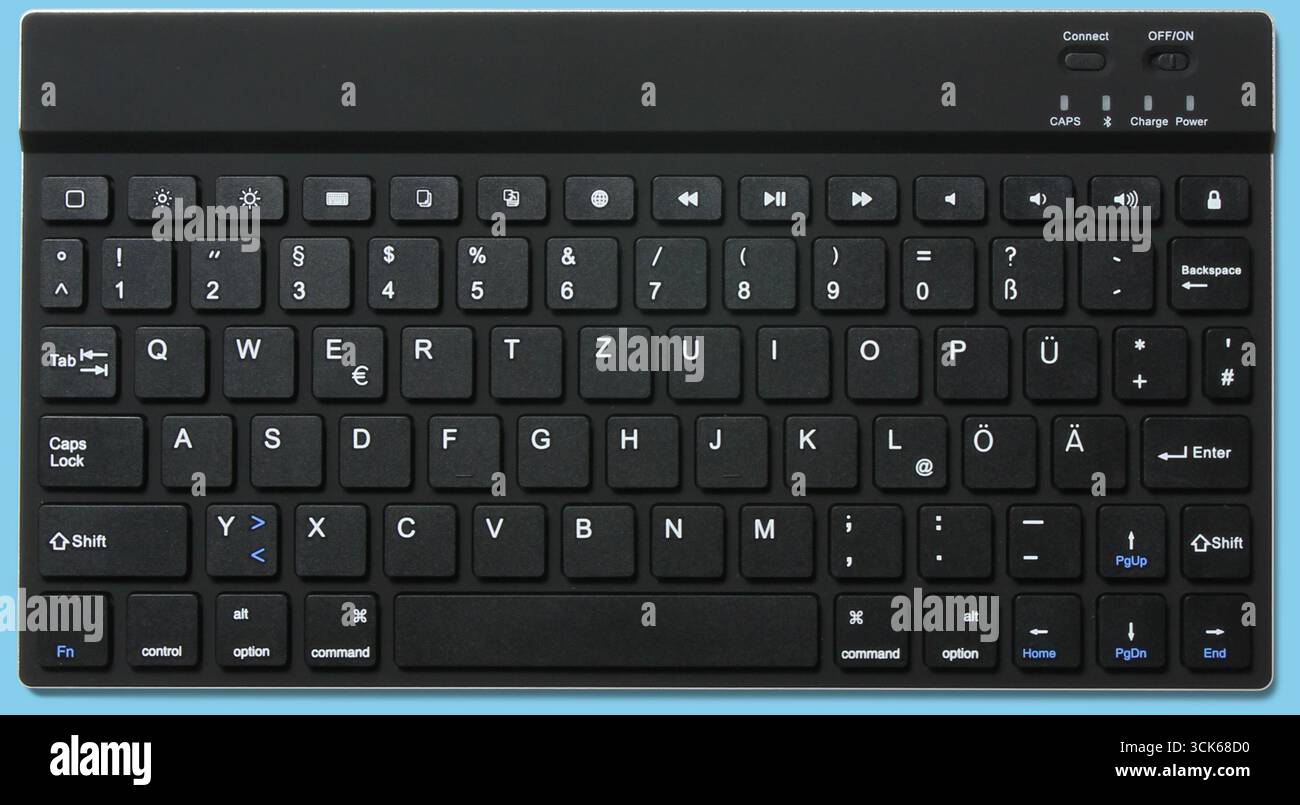 A wireless keyboard featuring a compact layout with multimedia keys for easy navigation and control. Stock Photo