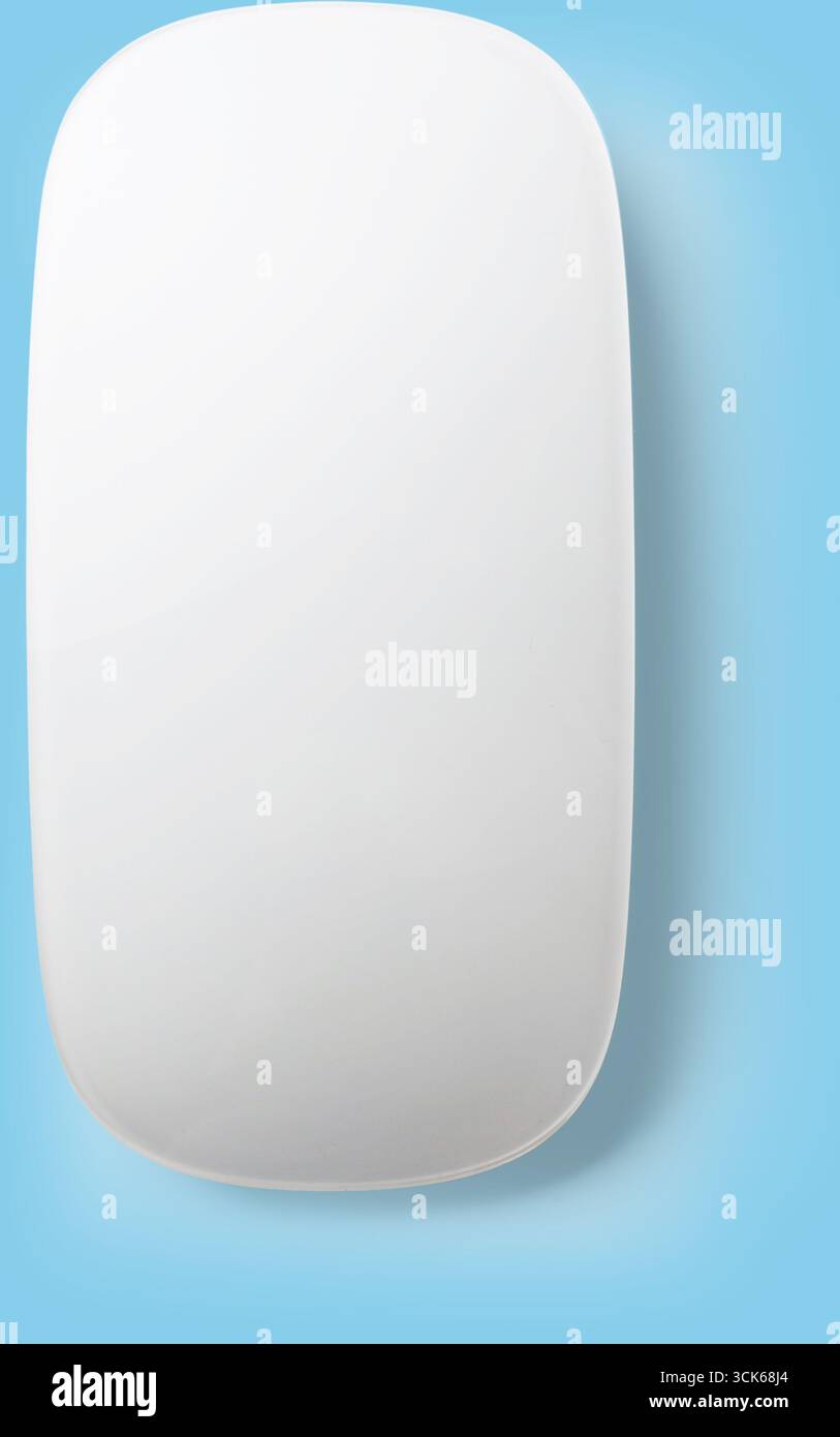 A sleek, minimalist white computer mouse designed for ergonomic use. Stock Photo