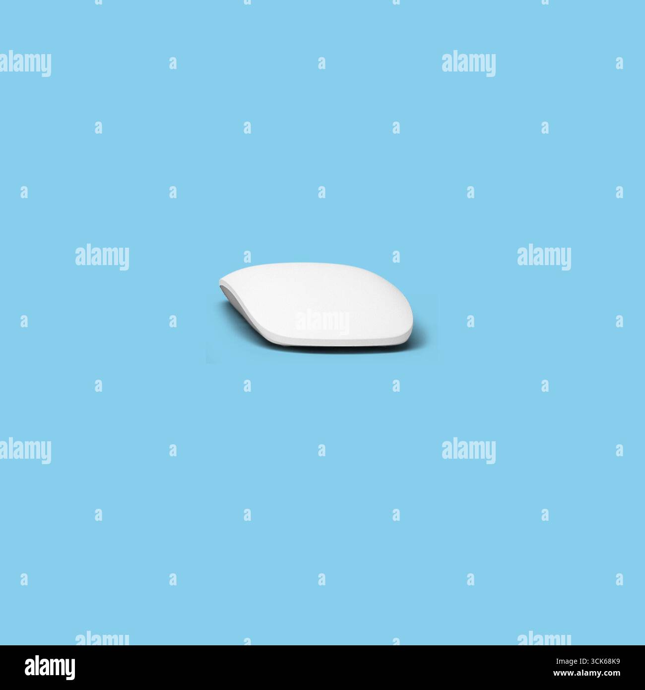 A sleek, minimalist computer mouse designed for ergonomic use. Stock Photo
