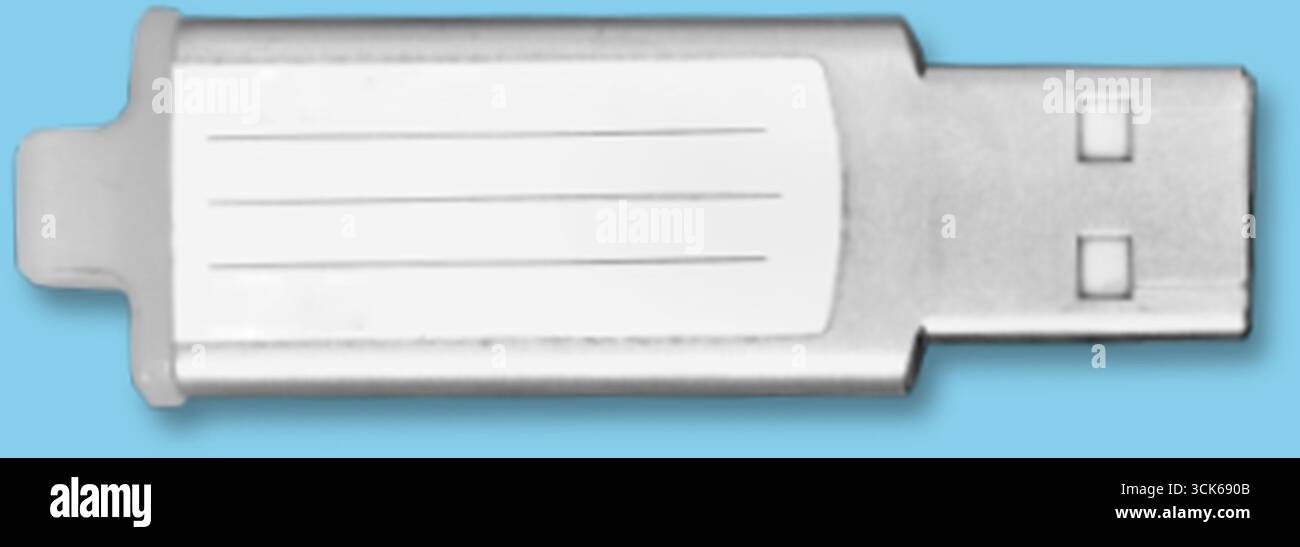 A silver USB flash drive with a blank label for customization. Stock Photo