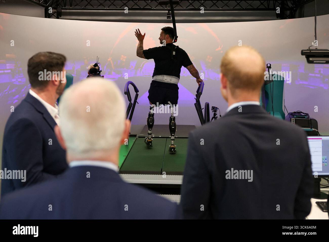 The Duke of Sussex (right) looks at Steve Arnold, who has competed in ...