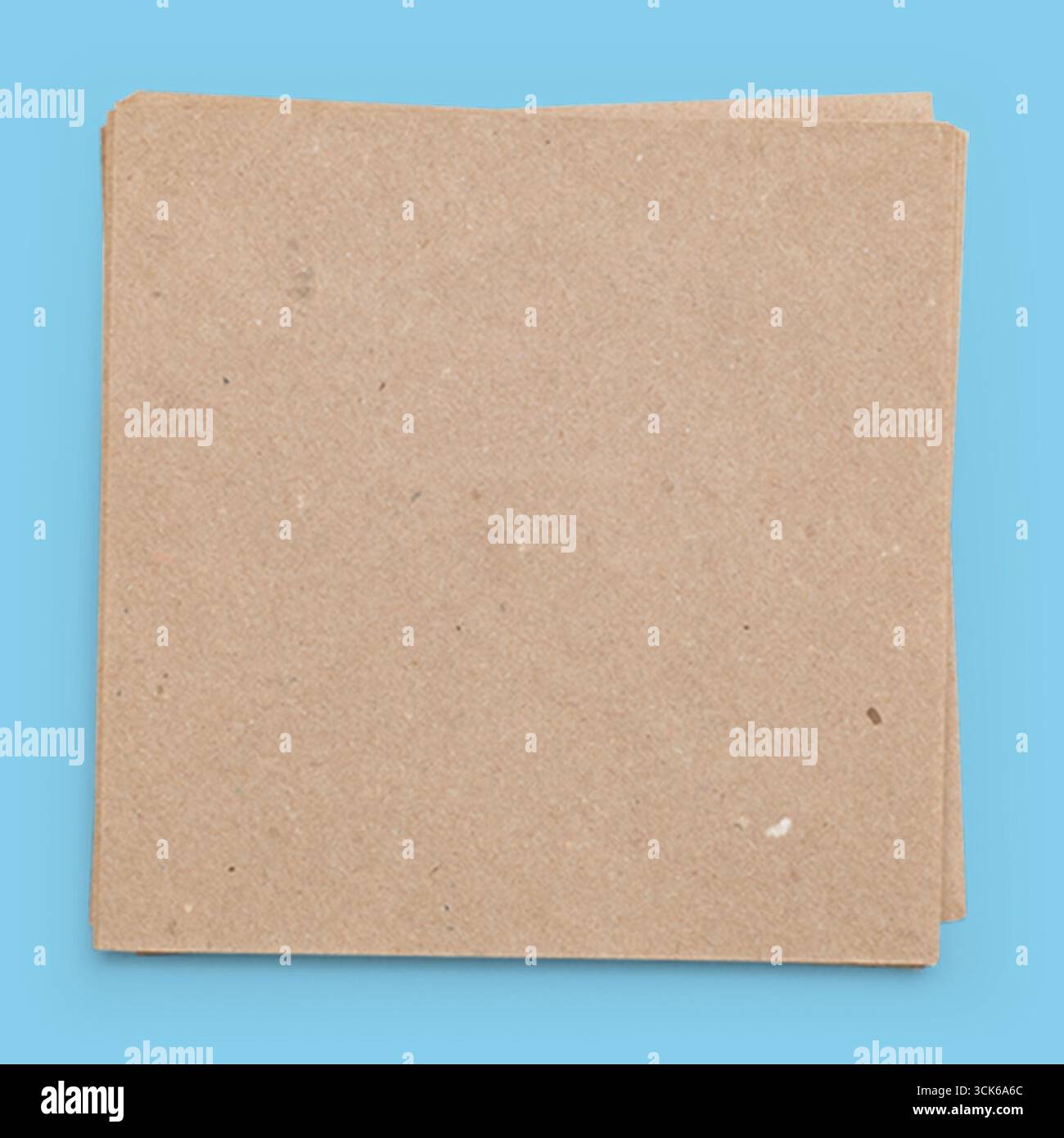 A stack of plain, brown, textured paper sheets, often used for crafts, notes, or packaging. Stock Photo