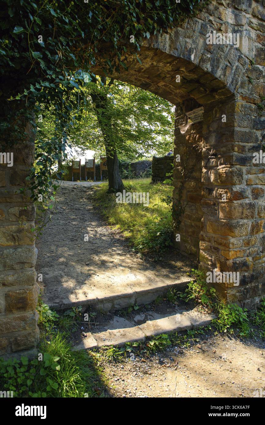 View from former kennel outside of castle to former castle gate entrance to today's castle ruins Isenburg in historic ring wall, Schellenberger Wald, Stock Photo