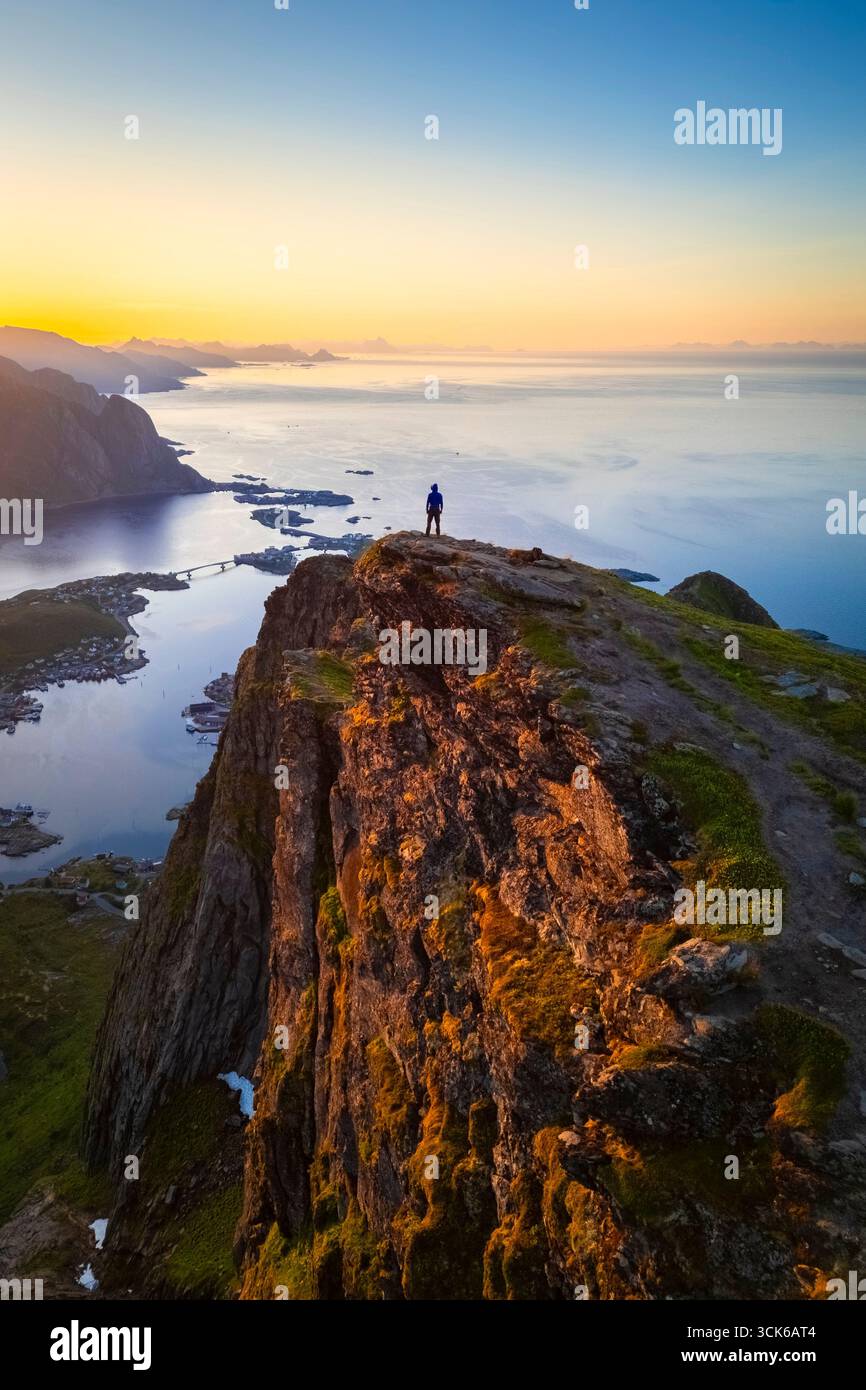 Aerial view of a sunrise at the top of Reinebringen mountain in summer during midnight sun. Reine, Moskenes, Nordland, Lofoten Islands, Norway. Stock Photo