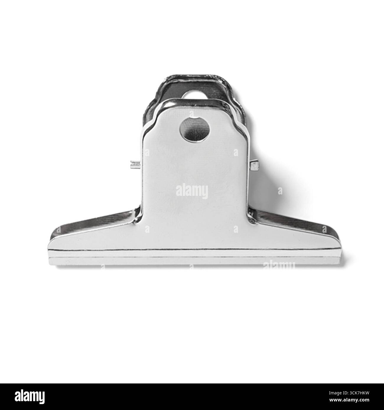 A metallic clipboard used for holding papers securely in place. Stock Photo