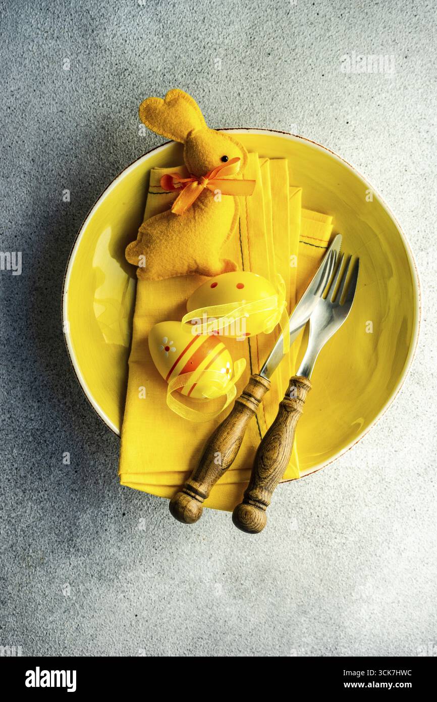 Easter dinner table settinf with colored eggs served on the table Stock Photo