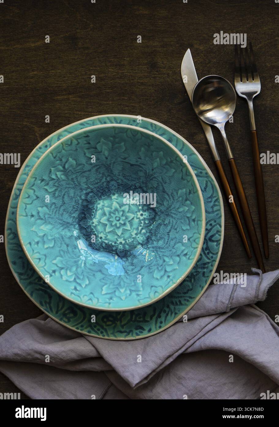 Rustic table setting with bright colored ceramic plates Stock Photo