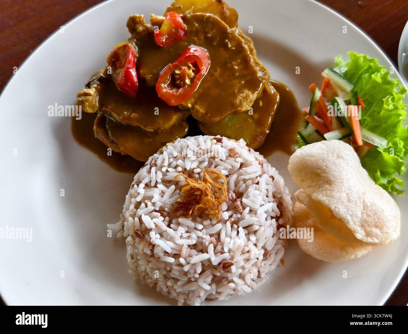 A serving of Indonesian style beef steak or bistik sapi with savory ...