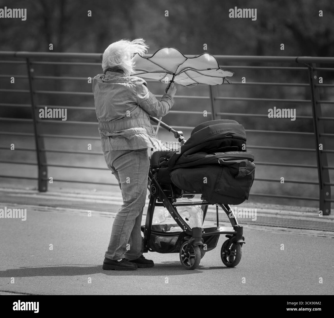 Woman with Baby Stroller and Broken Umbrella in Strong Wind, Paris 2020 Monochrome Photo Stock Photo
