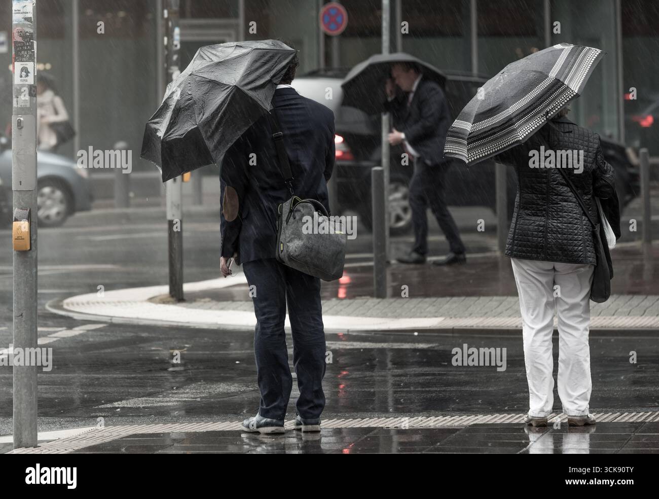 Rainy City Street with People Holding Umbrellas – Urban Lifestyle Photography Stock Photo