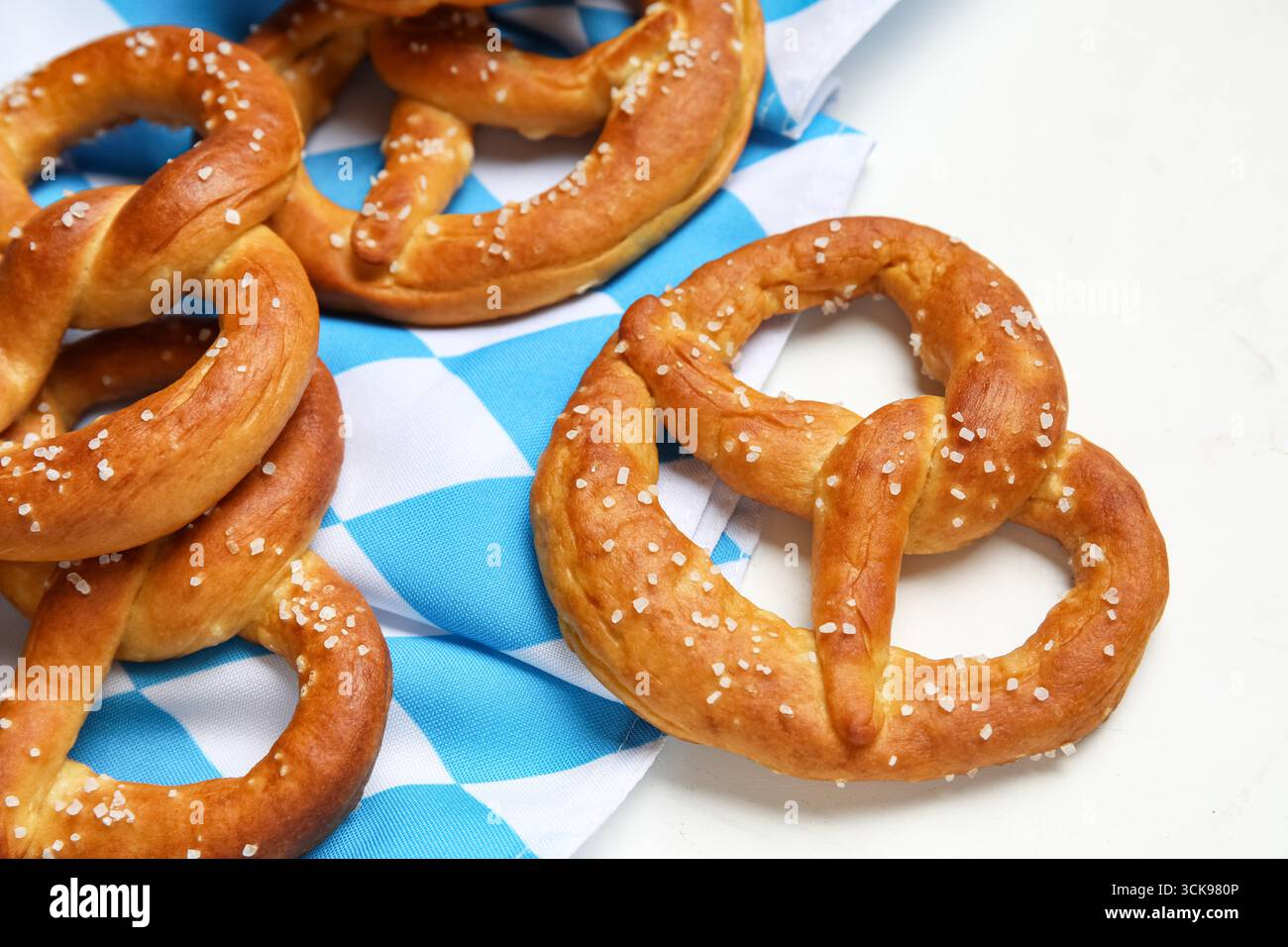 Napkin and tasty pretzels on marble background, closeup Stock Photo